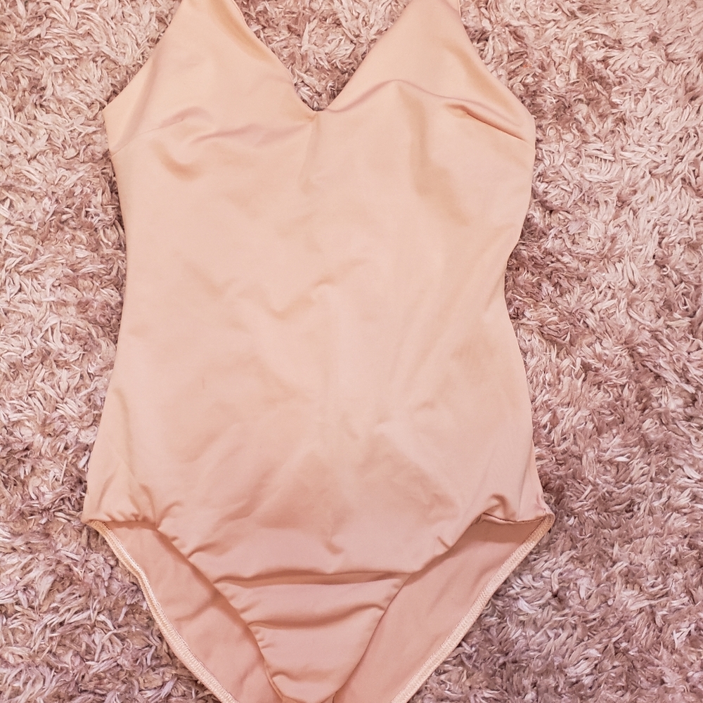 Beautiful strong body suit blush peach size Small. Never worn.